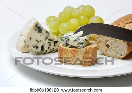 Stock Image - Roquefort on bread and fair, blue cheese, grapes, baguette. Fotosearch