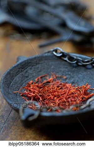 Picture - Saffron crocus threads (Crocus sativus) in weighing pan. Fotosearch