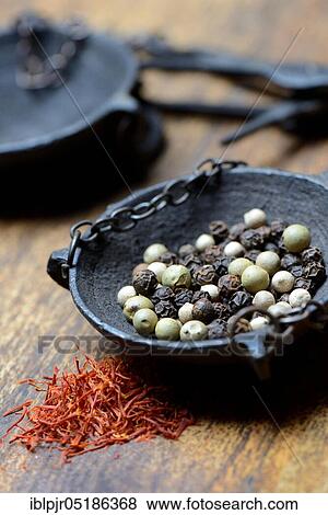 Saffron crocus threads (Crocus sativus) and peppercorns (Piper nigrum) in weighing pan View Large Photo Image Stock Photo - Saffron crocus threads (Crocus sativus) and peppercorns (Piper nigrum) in weighing pan. Fotosearch