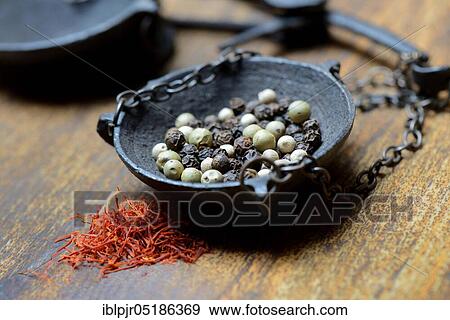 Saffron crocus threads (Crocus sativus) and peppercorns (Piper nigrum) in weighing pan View Large Photo Image Stock Photo - Saffron crocus threads (Crocus sativus) and peppercorns (Piper nigrum) in weighing pan. Fotosearch