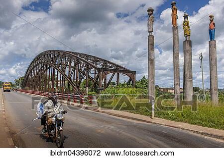 Sanaga River, German Colonial Era railway bridge, two men on a motorbike, Edéa, Littoral Region, Cameroon, Africa View Large Photo Image Stock Image - Sanaga River, German Colonial Era railway bridge, two men on a motorbike, Edéa, Littoral Region, Cameroon, Africa. Fotosearch