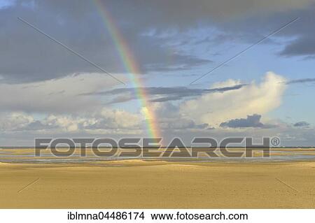 Picture - Sandy beach, clouds and rainbow, Borkum, East Frisian Island, East Frisia, Lower Saxony, Germany, Europe. Fotosearch