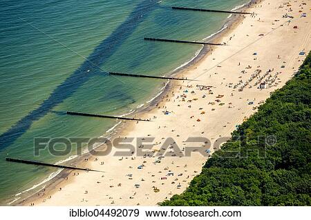 Stock Photo - Sandy beach with bathers, the Baltic Sea beach in Kołobrzeg, Kolobrzeg, Baltic Coast, West Pomerania Province, Poland, Europe. Fotosearch