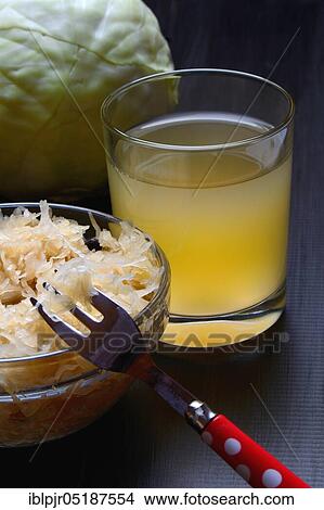 Picture - Sauerkraut and sauerkraut juice in glass, white cabbage. Fotosearch