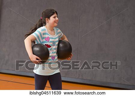 Schoolgirl playing ball in the gym, physical education, primary school, Lower Saxony, Germany, Europe View Large Photo Image Stock Photo - Schoolgirl playing ball in the gym, physical education, primary school, Lower Saxony, Germany, Europe. Fotosearch