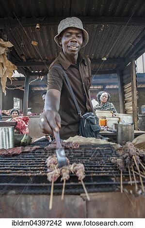 Seller grilling meat at street stand, street scene, Bamenda, North-West Region, Cameroon, Africa View Large Photo Image Stock Image - Seller grilling meat at street stand, street scene, Bamenda, North-West Region, Cameroon, Africa. Fotosearch