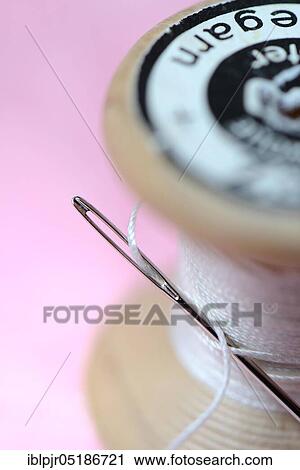 Stock Image - Sewing needle and thread roll. Fotosearch