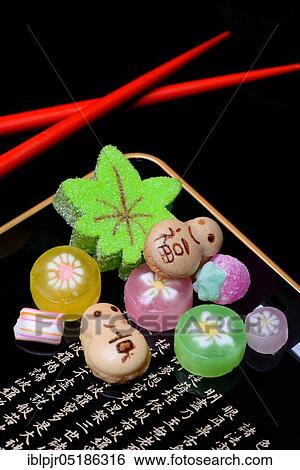 Stock Photograph - shi, Japanese sweets on tray with characters, candy, sweets. Fotosearch