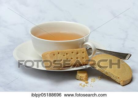 Stock Photograph - Shortbread, shortbread fingers, shortbread rounds, and cup of tea, English butter pastry, Tea Time. Fotosearch