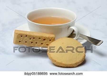 Stock Photography - Shortbread, shortbread fingers, shortbread rounds, and cup of tea, English butter pastry, Tea Time. Fotosearch