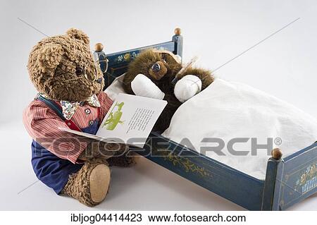 Sick Teddy Bear with head and paws bandaged, holding thermometer, in an original Pumuckl crib, Big Teddy Bear in glasses and bow tie reads from book background View Large Photo Image Stock Image - Sick Teddy Bear with head and paws bandaged, holding thermometer, in an original Pumuckl crib, Big Teddy Bear in glasses and bow tie reads from book background. Fotosearch