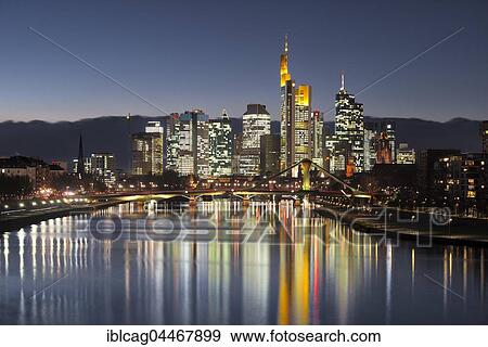 Stock Photo - Skyline at dusk, brightly lit, blue hour, reflection, Deutschherrnbrücke, Frankfurt, Hesse, Germany, Europe. Fotosearch