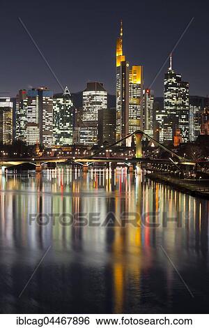 Skyline at dusk, brightly lit, blue hour, reflection, Deutschherrnbrücke, Frankfurt, Hesse, Germany, Europe View Large Photo Image Stock Photograph - Skyline at dusk, brightly lit, blue hour, reflection, Deutschherrnbrücke, Frankfurt, Hesse, Germany, Europe. Fotosearch