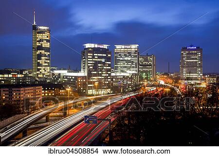 Picture - Skyline, light trails with A40 in front of the skyscrapers of RWE, Evonik and Postbank, Twilight, Essen, North Rhine-Westphalia, Germany, Europe. Fotosearch