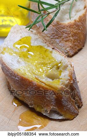 Slice of bread with olive oil, Mediterranean, Mediterranean diet, rosemary View Large Photo Image Picture - Slice of bread with olive oil, Mediterranean, Mediterranean diet, rosemary. Fotosearch