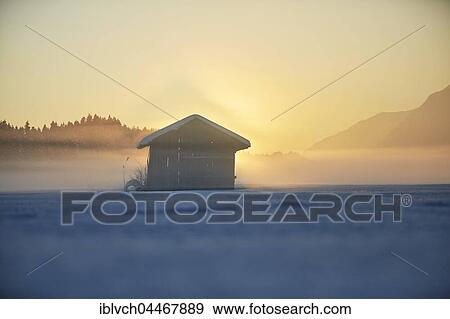Stock Photo - Small cabin, winter landscape, hay barn in fog at dusk, Kramsach, Tyrol, Austria, Europe. Fotosearch