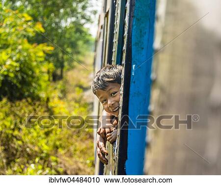 Small local boy looking out of moving train, Yangon Circular Railway, Yangon, Myanmar, Asia View Large Photo Image Stock Image - Small local boy looking out of moving train, Yangon Circular Railway, Yangon, Myanmar, Asia. Fotosearch