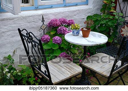 Small round table and chairs, bistro table, hydrangeas View Large Photo Image Stock Image - Small round table and chairs, bistro table, hydrangeas. Fotosearch