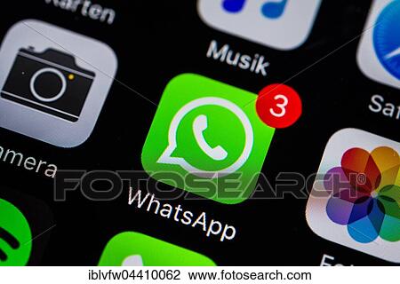 Stock Image - Smartphone screen with WhatsApp icon. Fotosearch