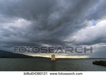 Spanish Windmill in lagoon, dark sky behind, Orbetello, Tuscany, Italy, Europe View Large Photo Image Stock Image - Spanish Windmill in lagoon, dark sky behind, Orbetello, Tuscany, Italy, Europe. Fotosearch