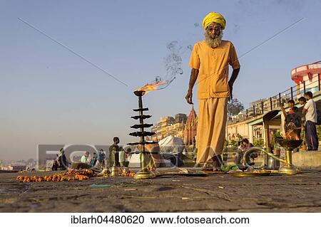 Stock Image - Spiritual morning prayer on the Ganges, Varanasi, Uttar Pradesh, India, Asia. Fotosearch
