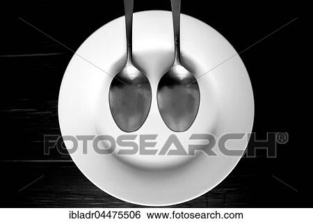 Spoons on plate, laughing face View Large Photo Image Stock Photograph - Spoons on plate, laughing face. Fotosearch