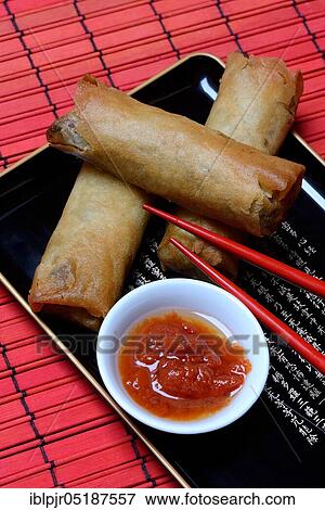 Stock Photo - Spring roll and bowl with sauce. Fotosearch