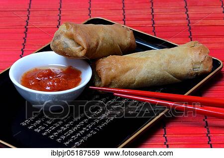 Stock Photo - Spring roll and bowl with sauce. Fotosearch