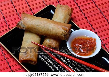 Stock Photograph - Spring roll and bowl with sauce. Fotosearch
