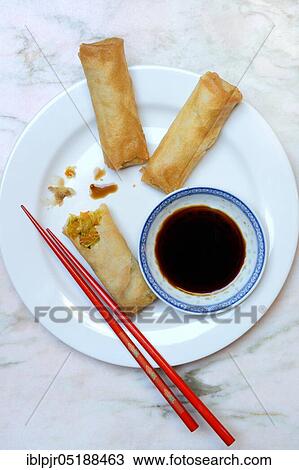 Stock Image - Spring rolls with soy sauce. Fotosearch