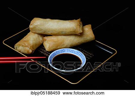 Stock Photo - Spring rolls with soy sauce. Fotosearch