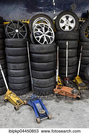 Stacked tires and car jacks, garage, Phnom Penh Province, Cambodia, Asia View Large Photo Image Stock Image - Stacked tires and car jacks, garage, Phnom Penh Province, Cambodia, Asia. Fotosearch