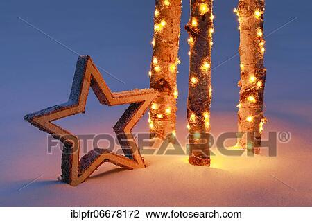 Star with illuminated birch trunks in the snow View Large Photo Image Stock Image - Star with illuminated birch trunks in the snow. Fotosearch