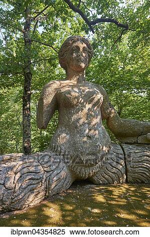 Statue of Echidina, mother of the many enemies of Hercules, Park of Monsters or The Sacred Wood of Bamarzo, Bomarzo, Lazio, Italy, Europe View Large Photo Image Stock Photography - Statue of Echidina, mother of the many enemies of Hercules, Park of Monsters or The Sacred Wood of Bamarzo, Bomarzo, Lazio, Italy, Europe. Fotosearch