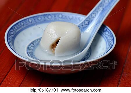 Stock Image - Sticky rice balls with peanut filling, Asian spoon. Fotosearch