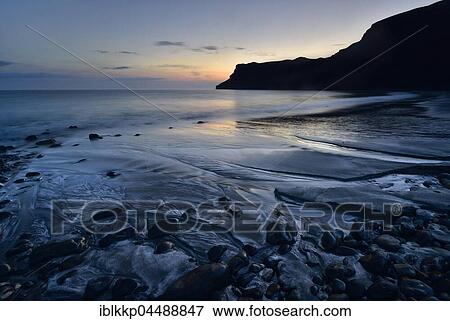 Stock Photo - Stones in the sand on the beach of Talisker Bay, Cliff, Isle of Skye, Scotland, United Kingdom, Europe. Fotosearch