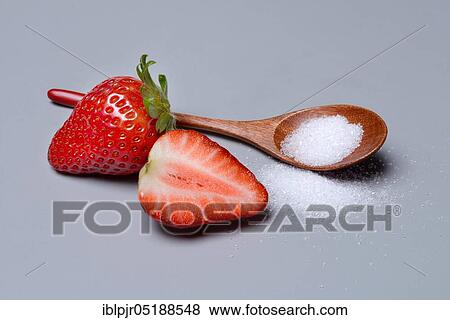 Stock Photo - Strawberries and sugar with spoon, sugar consumption, white sugar. Fotosearch