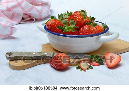 Picture - Strawberries in skin on wooden board. Fotosearch