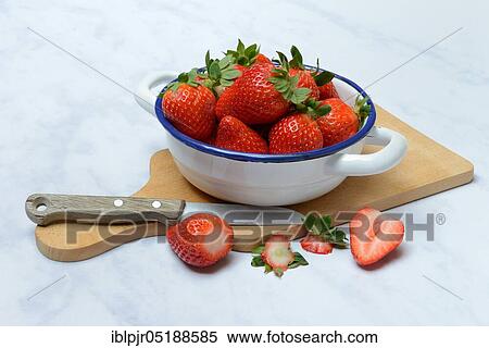 Stock Photography - Strawberries in skin on wooden board. Fotosearch