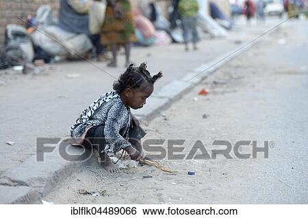 Stock Photograph - Street child, little girl playing on the side of the road, Fianarantsoa province, Madagascar, Africa. Fotosearch