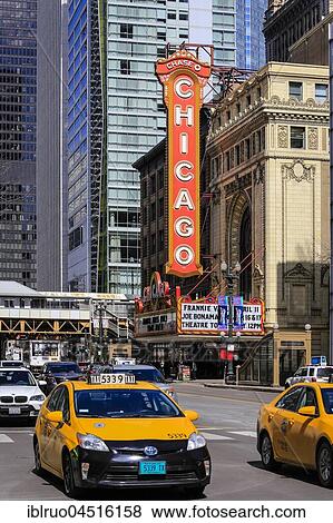 Stock Photo - Street scene with taxi at Chicago Theater, Chicago, Illinois, USA, North America. Fotosearch