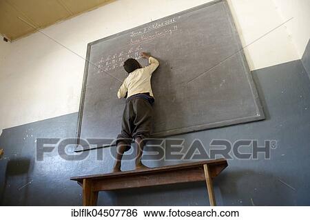 Student, boy writing at blackboard in primary school, Fianarantsoa, Madagascar, Africa View Large Photo Image Stock Photograph - Student, boy writing at blackboard in primary school, Fianarantsoa, Madagascar, Africa. Fotosearch