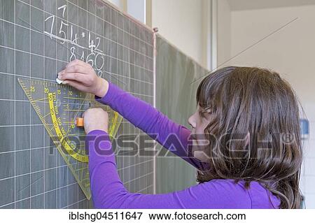 Stock Photo - Student calculating on the blackboard, mathematics lesson, primary school, Lower Saxony, Germany, Europe. Fotosearch