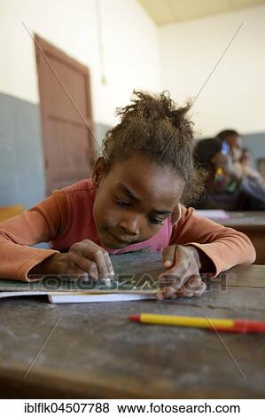 Stock Photo - Student, girl writing, 10 years, Primary School, Fianarantsoa, Madagascar, Africa. Fotosearch
