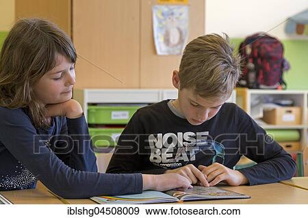 Students, children reading a book together, classroom, elementary school, Lower Saxony, Germany, Europe View Large Photo Image Stock Photo - Students, children reading a book together, classroom, elementary school, Lower Saxony, Germany, Europe. Fotosearch