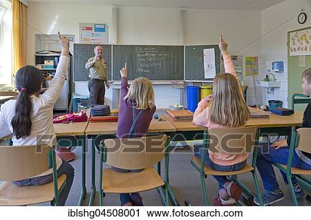 Students in elementary school with raised hands in classroom, Lower Saxony, Germany, Europe View Large Photo Image Stock Image - Students in elementary school with raised hands in classroom, Lower Saxony, Germany, Europe. Fotosearch