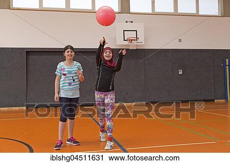 Stock Image - Students playing ball in the gym, physical education, primary school, Lower Saxony, Germany, Europe. Fotosearch