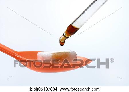 Picture - Sugar cubes on spoon, drops on pipette. Fotosearch
