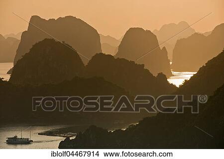 Sunset, limestone cliffs with vegetation in Halong Bay, Gulf of Tonkin, North Vietnam, Vietnam, Asia View Large Photo Image Picture - Sunset, limestone cliffs with vegetation in Halong Bay, Gulf of Tonkin, North Vietnam, Vietnam, Asia. Fotosearch