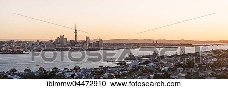 Stock Image - Sunset, Waitemata Harbour, Sky Tower, skyline with skyscrapers, Central Business District, Auckland Region, North Island, New Zealand, Oceania. Fotosearch